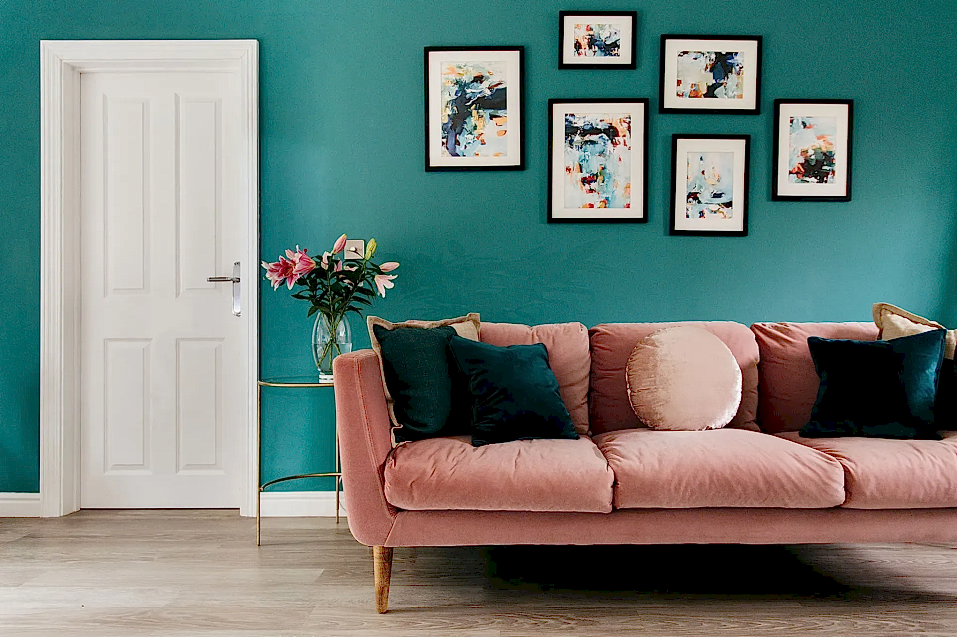 Symmetrical gallery wall | Black frames on turquoise wall