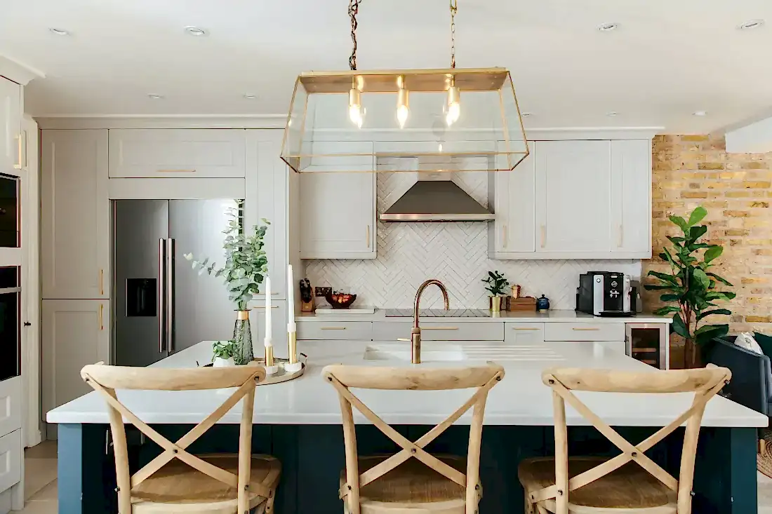 Kitchen island with grey cabinets and crown molding behind