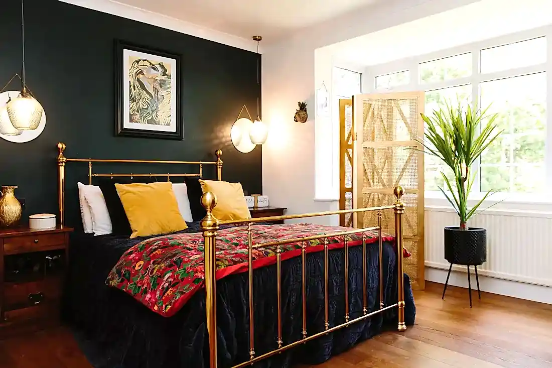 Industrial style bedroom with dark olive walls