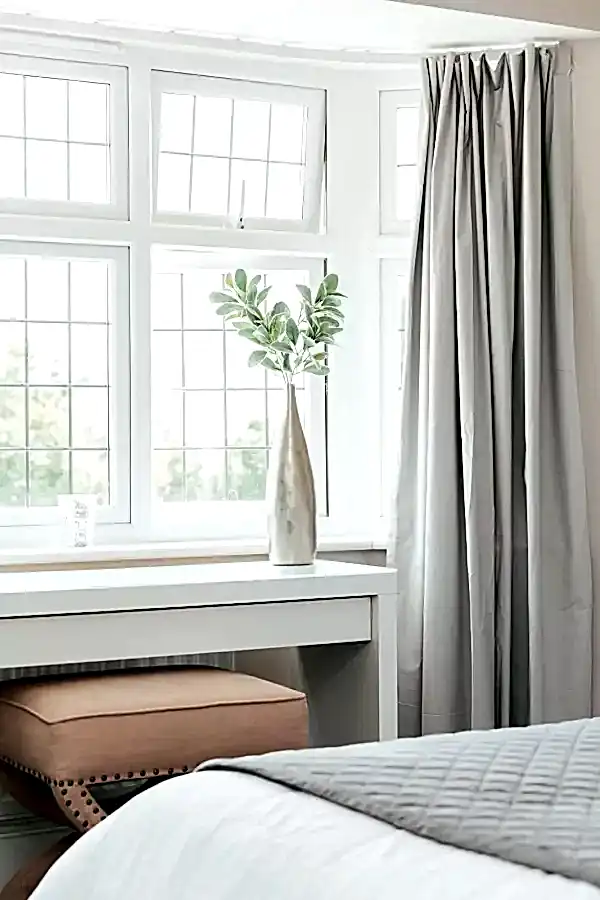 Bedroom window letting in the natural light causing positive mental health benefits