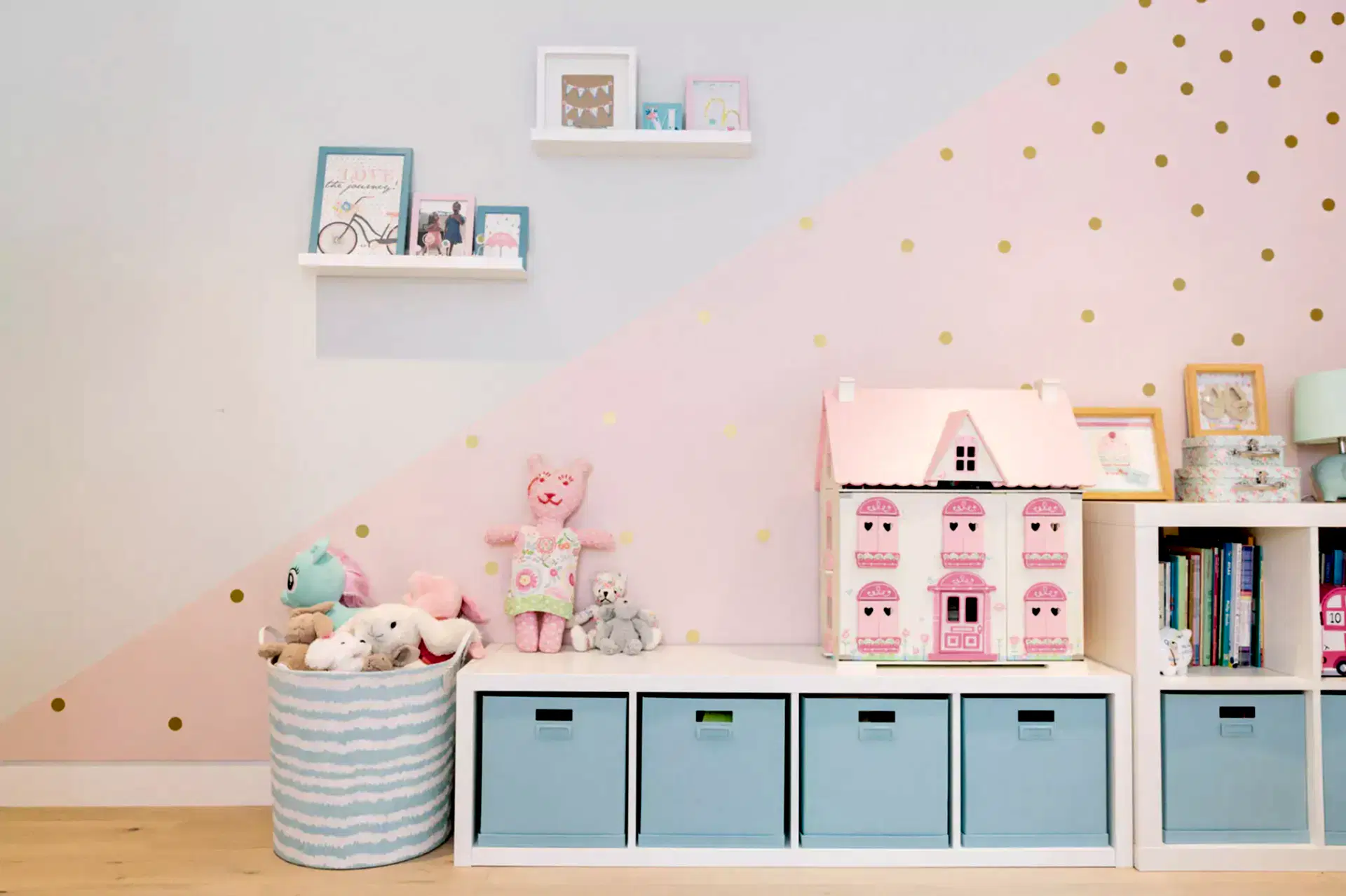 Childrens pastel pink and blue bedroom with wall mural