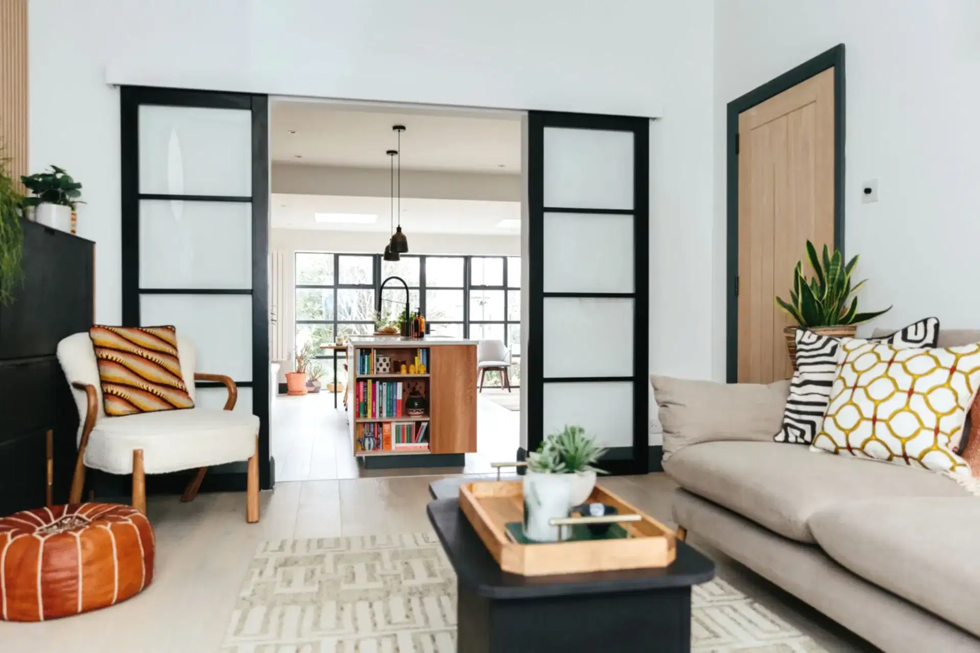 black and white living room with orange accents