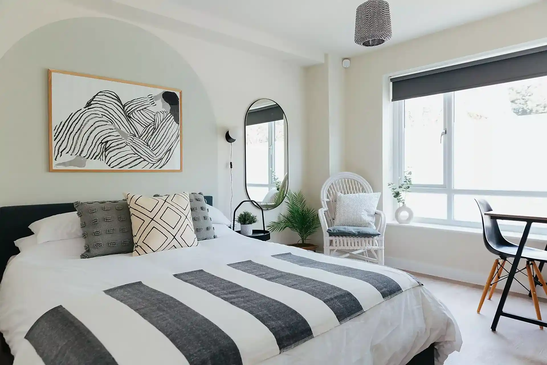 Calming guest bedroom with painted arch headboard