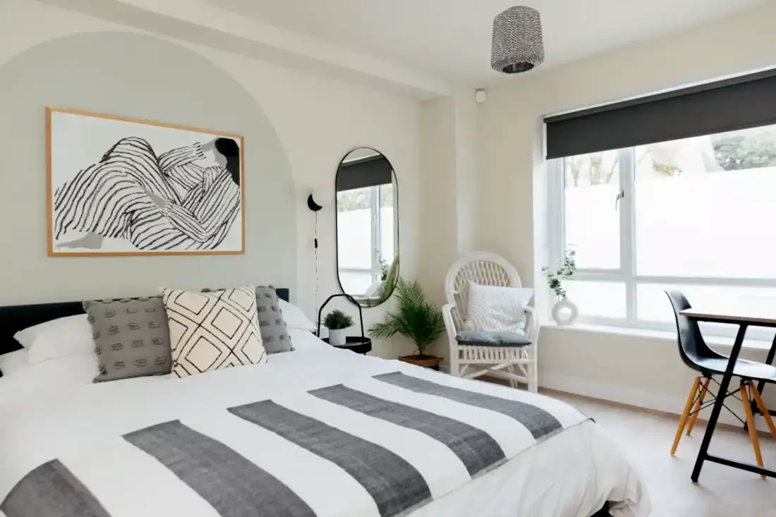 Coastal bedroom with wall painted curved headboard