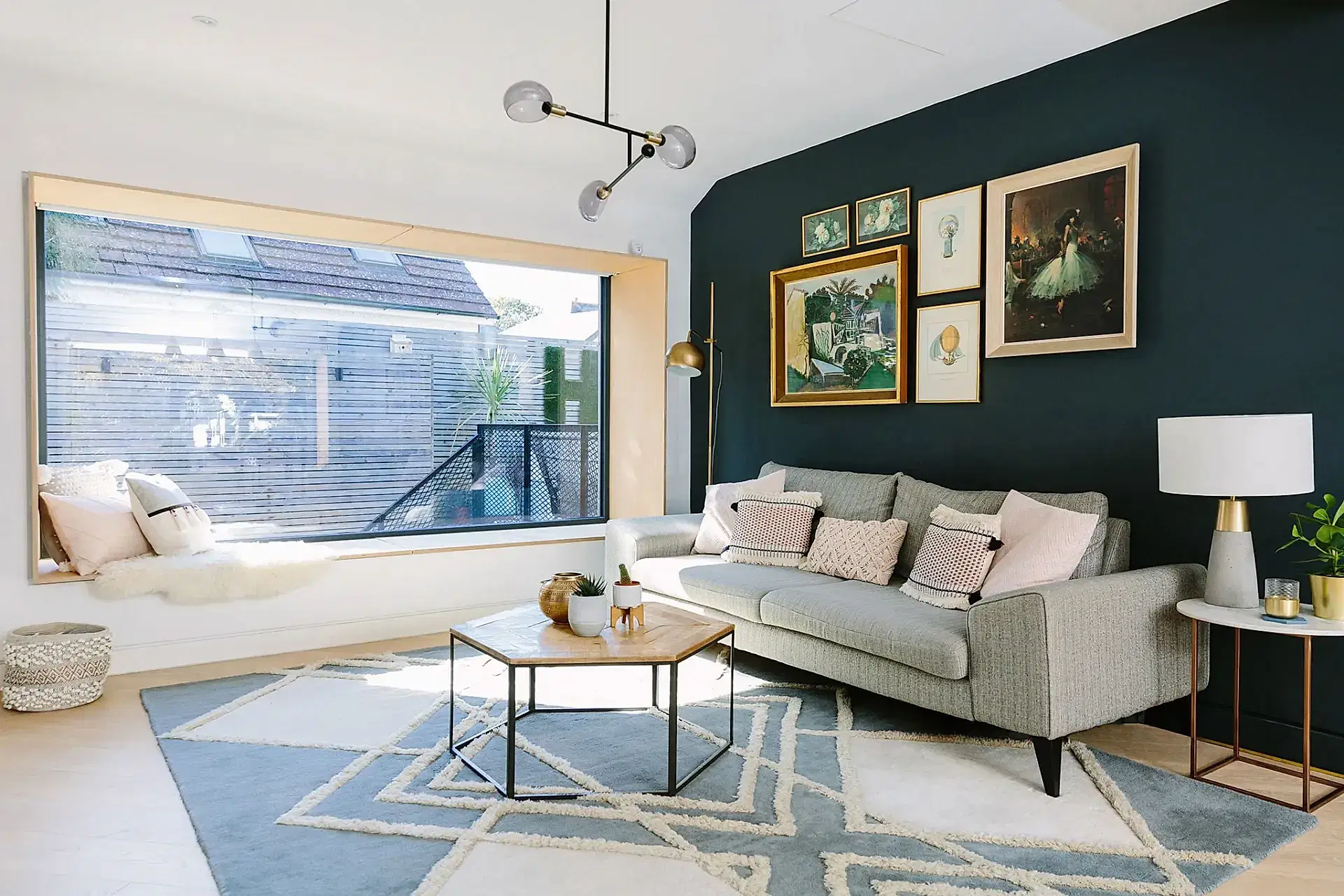 Living room with dark accent wall and gallery wall
