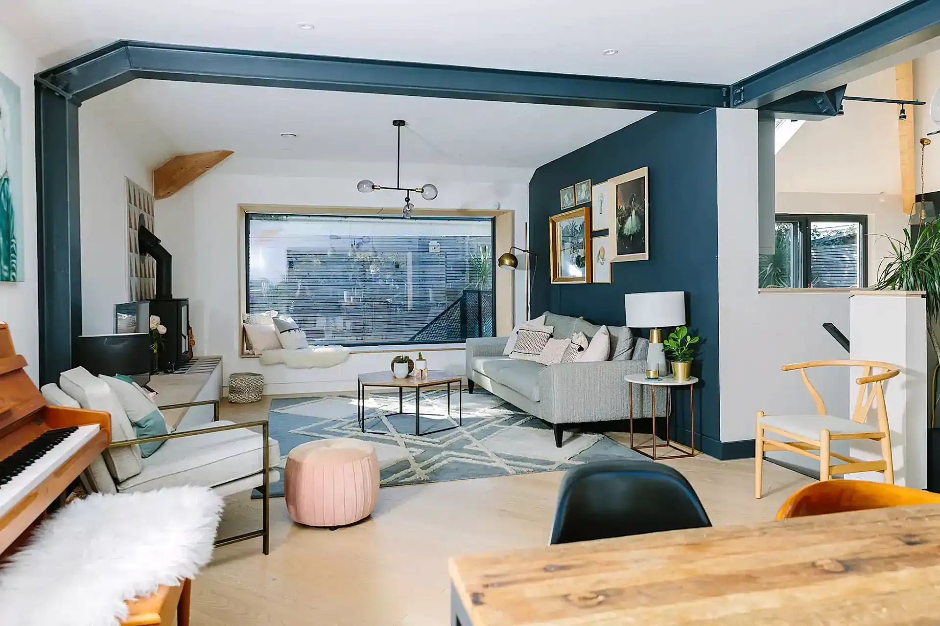 Open plan living area wit blue accent wall | Online interior design