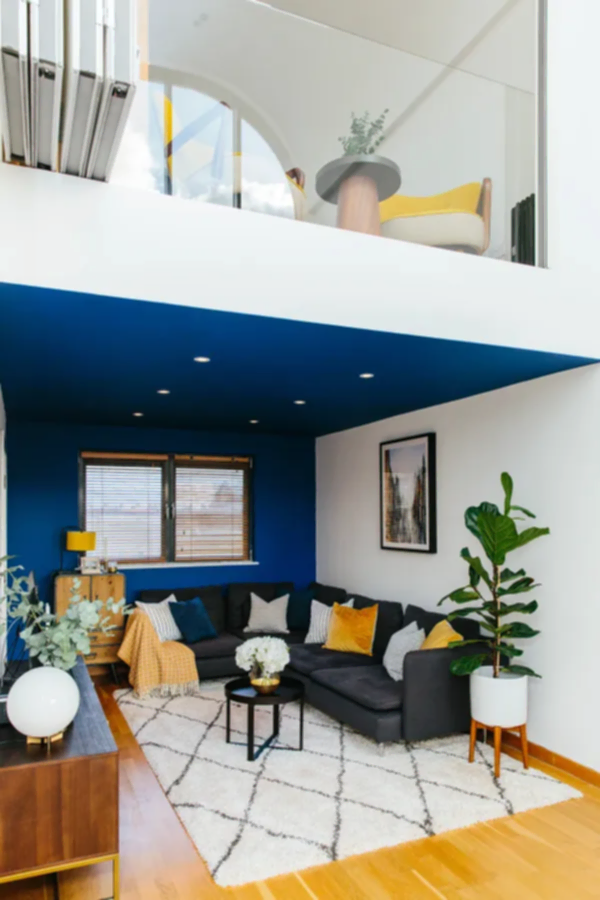Modern open plan home with dark blue painted ceiling