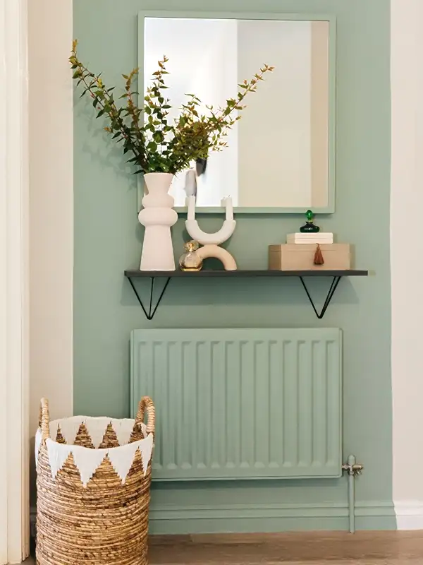 Sage green accent wall to hide radiators