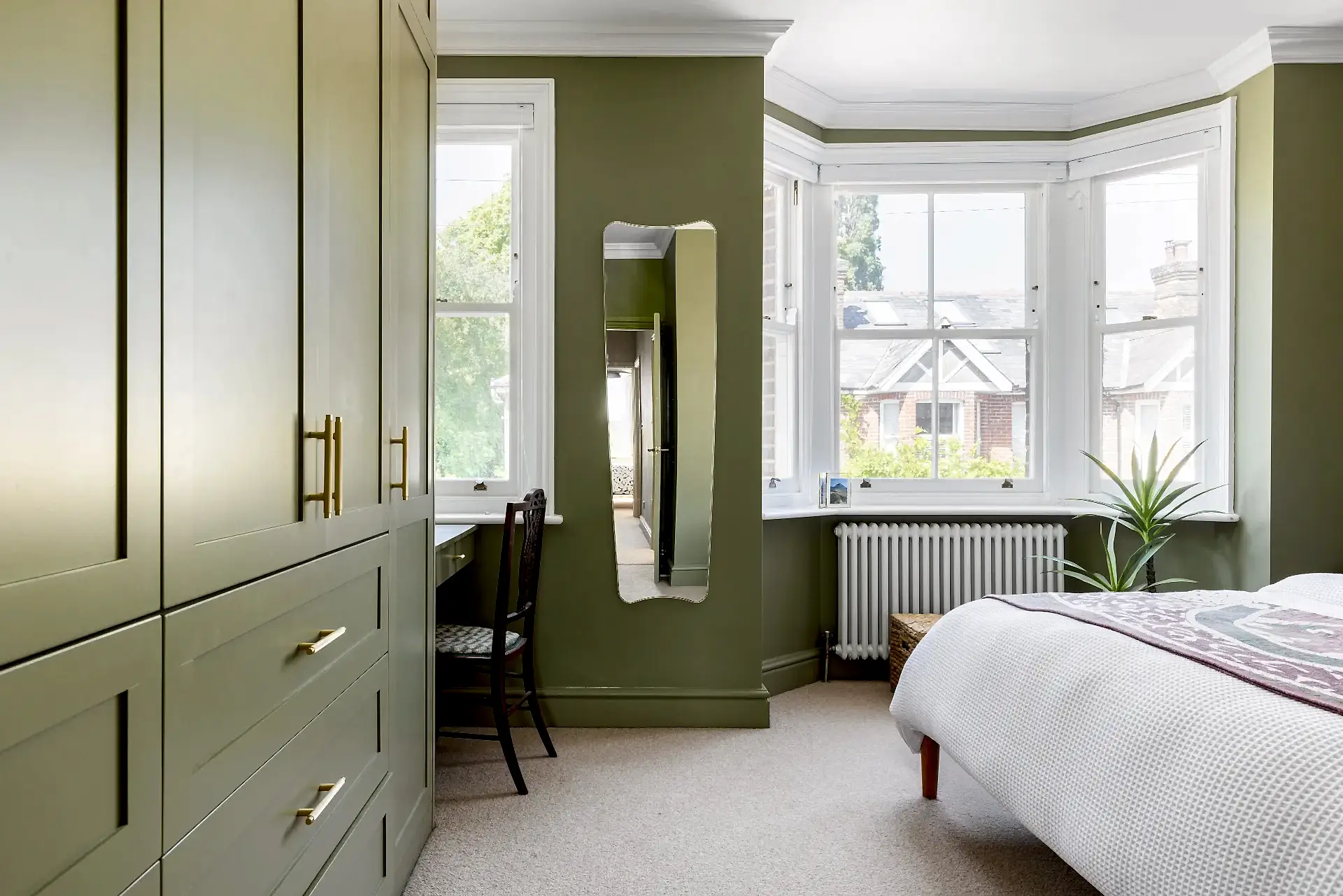 Modern wardrobe in green bedroom