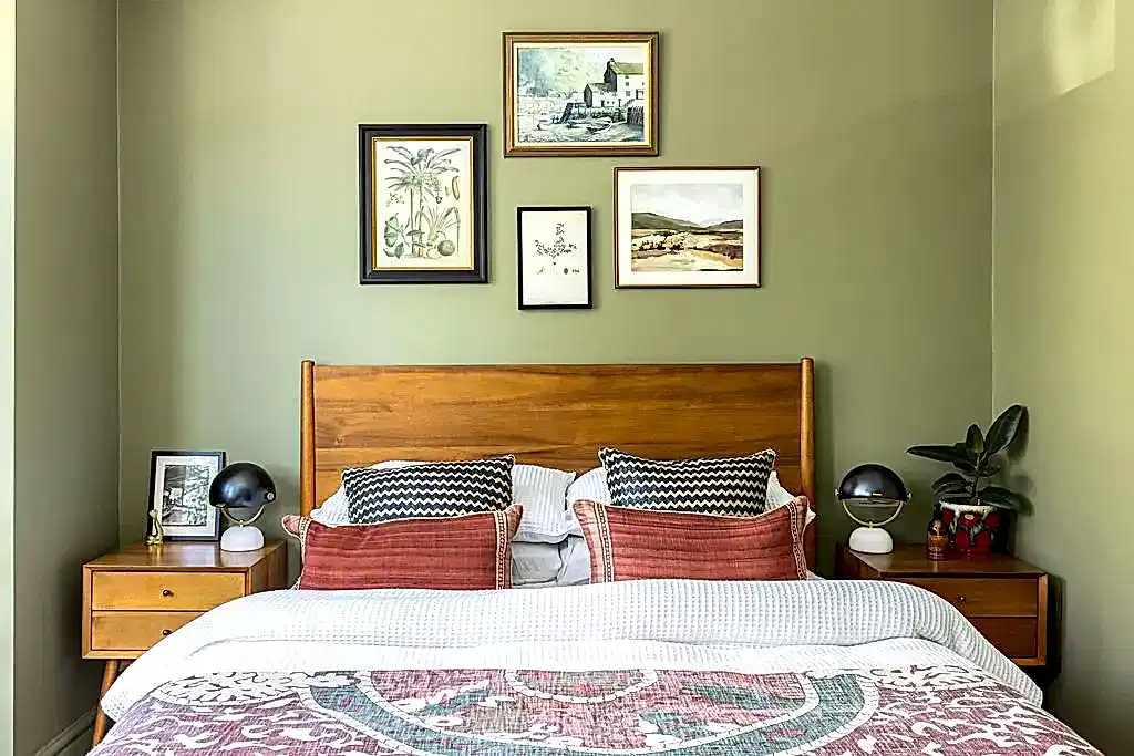 green bedroom with gallery wall