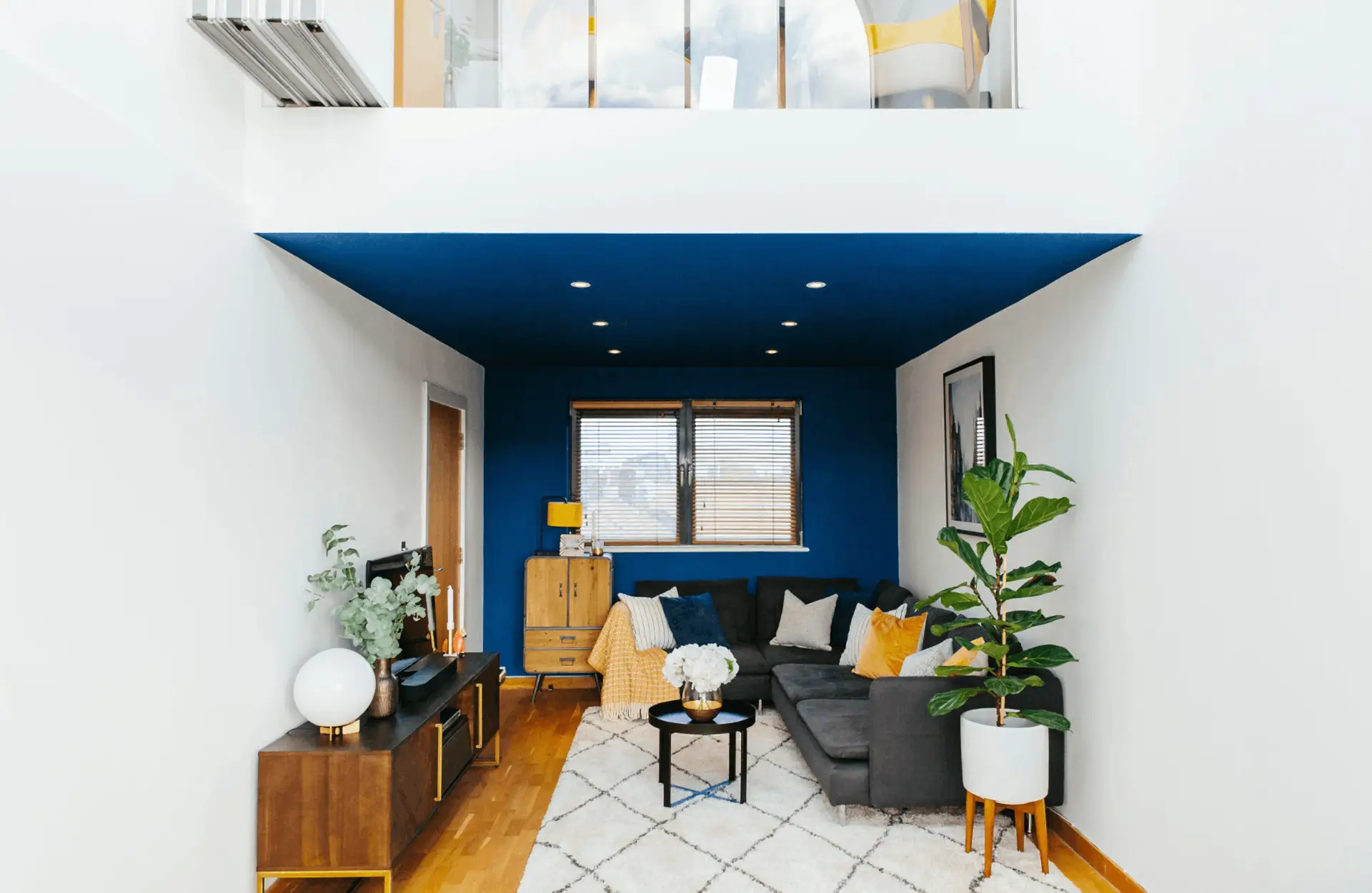 blue and white living room with corner sofa