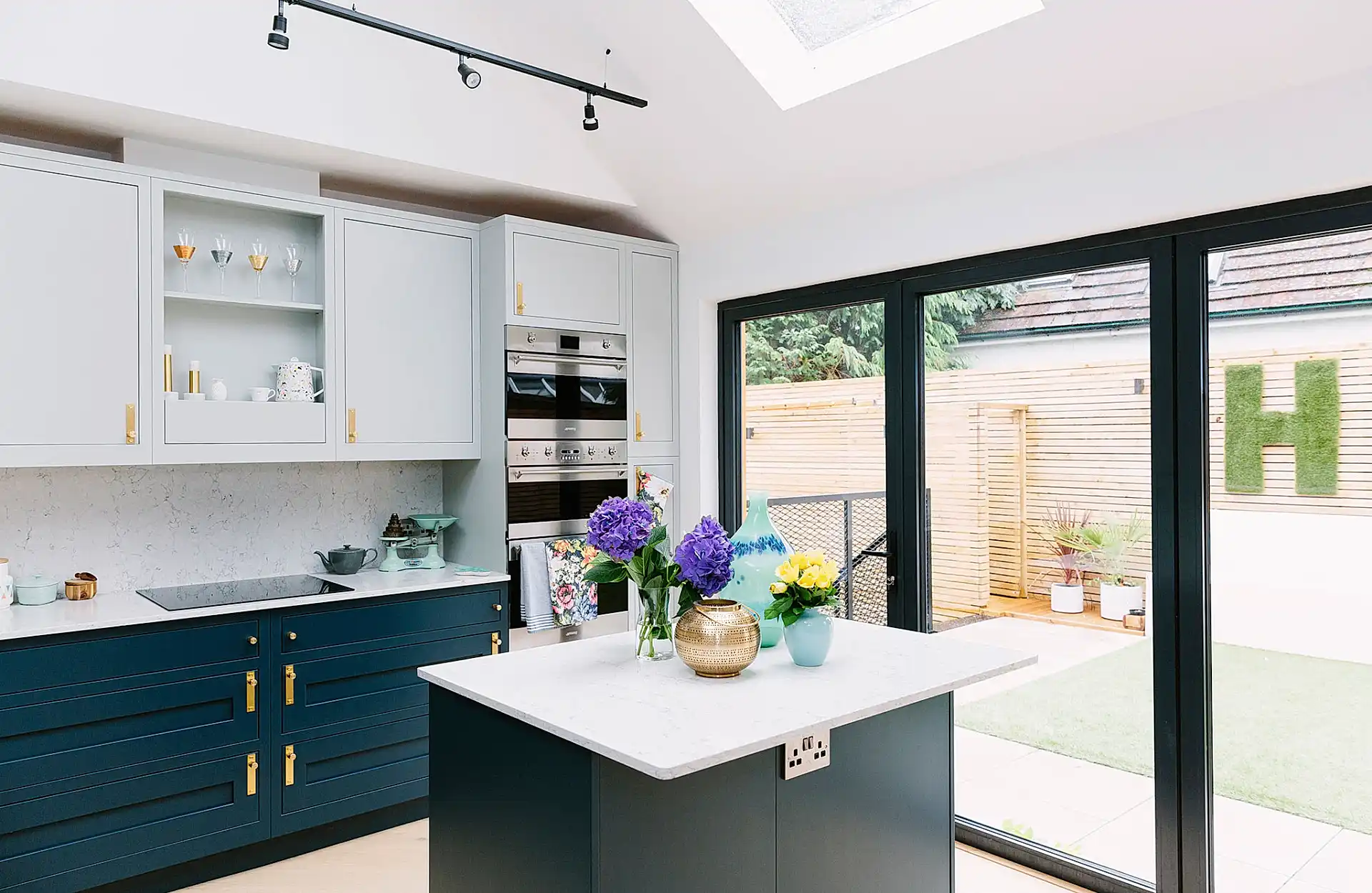 blue and white kitchen with island and gold details