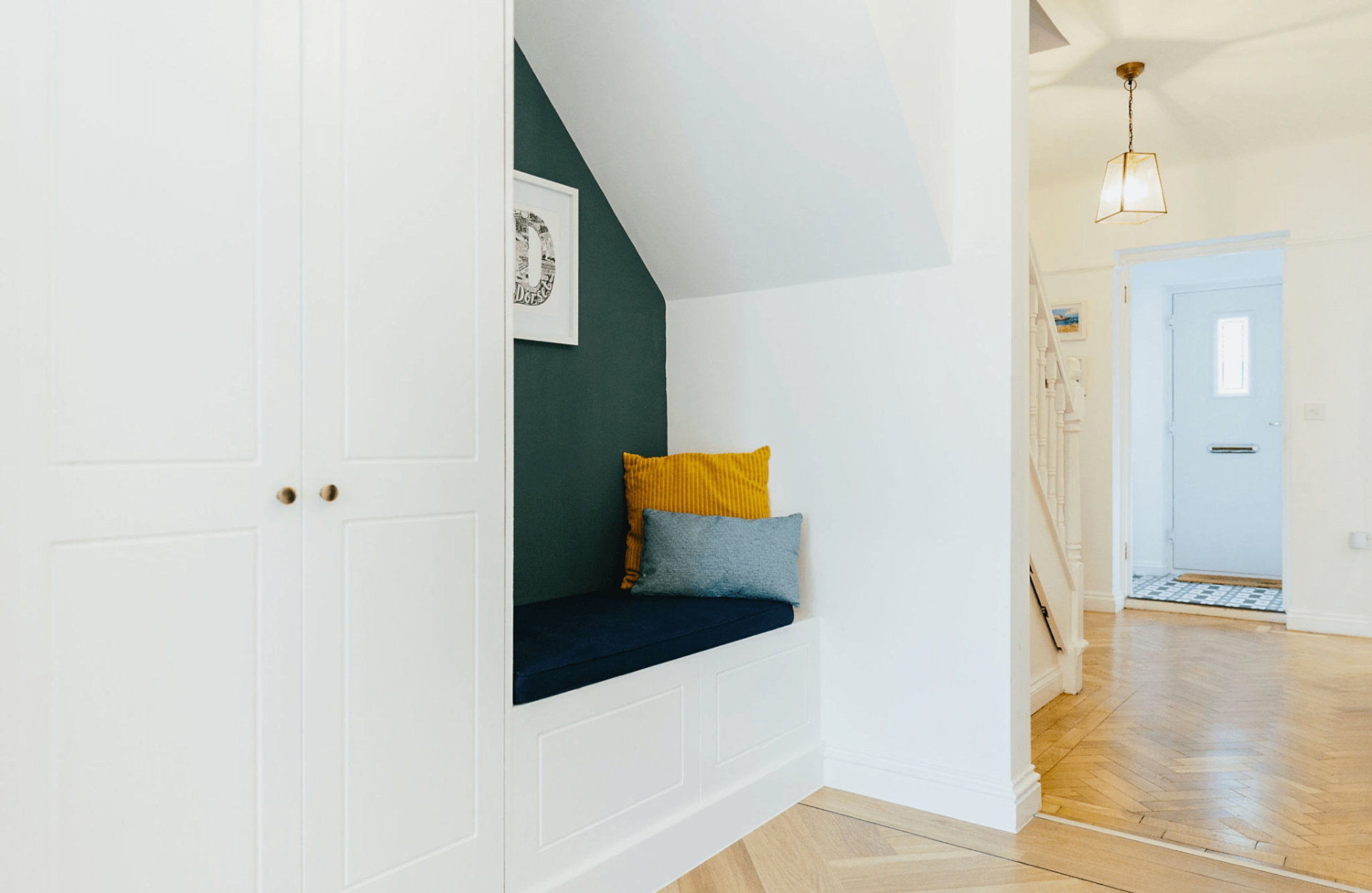 Hallway with seating under stairs