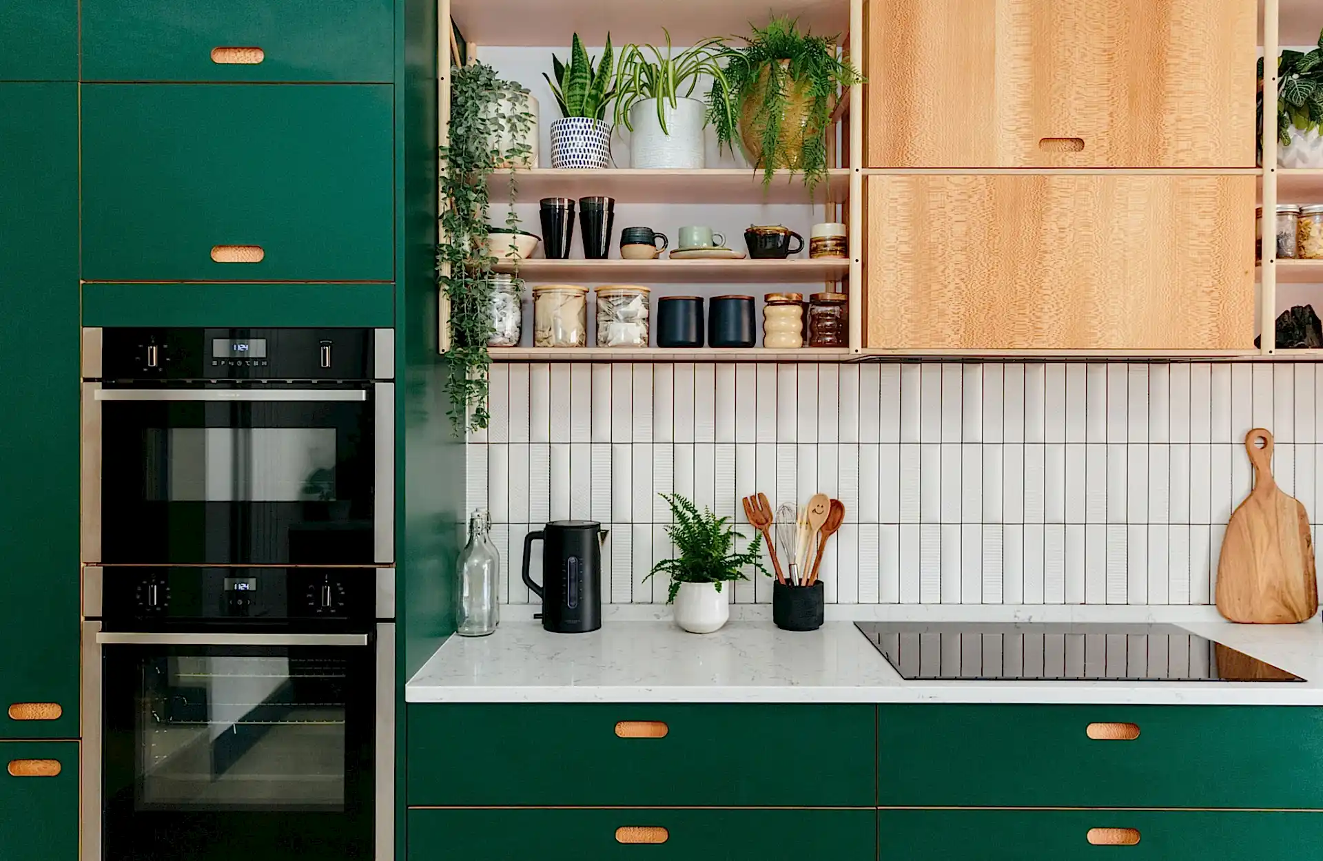 Kitchen with green cabinets and white tile backsplash