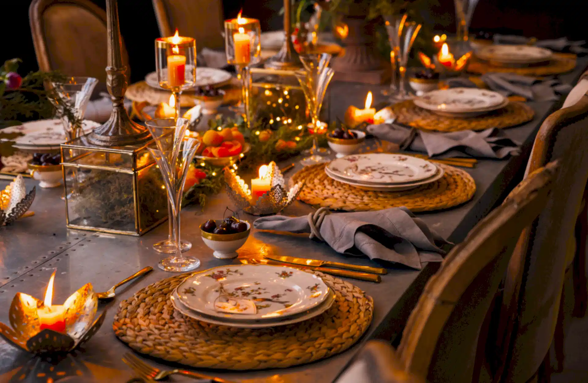 Warm christmas table scape with candles and oranges