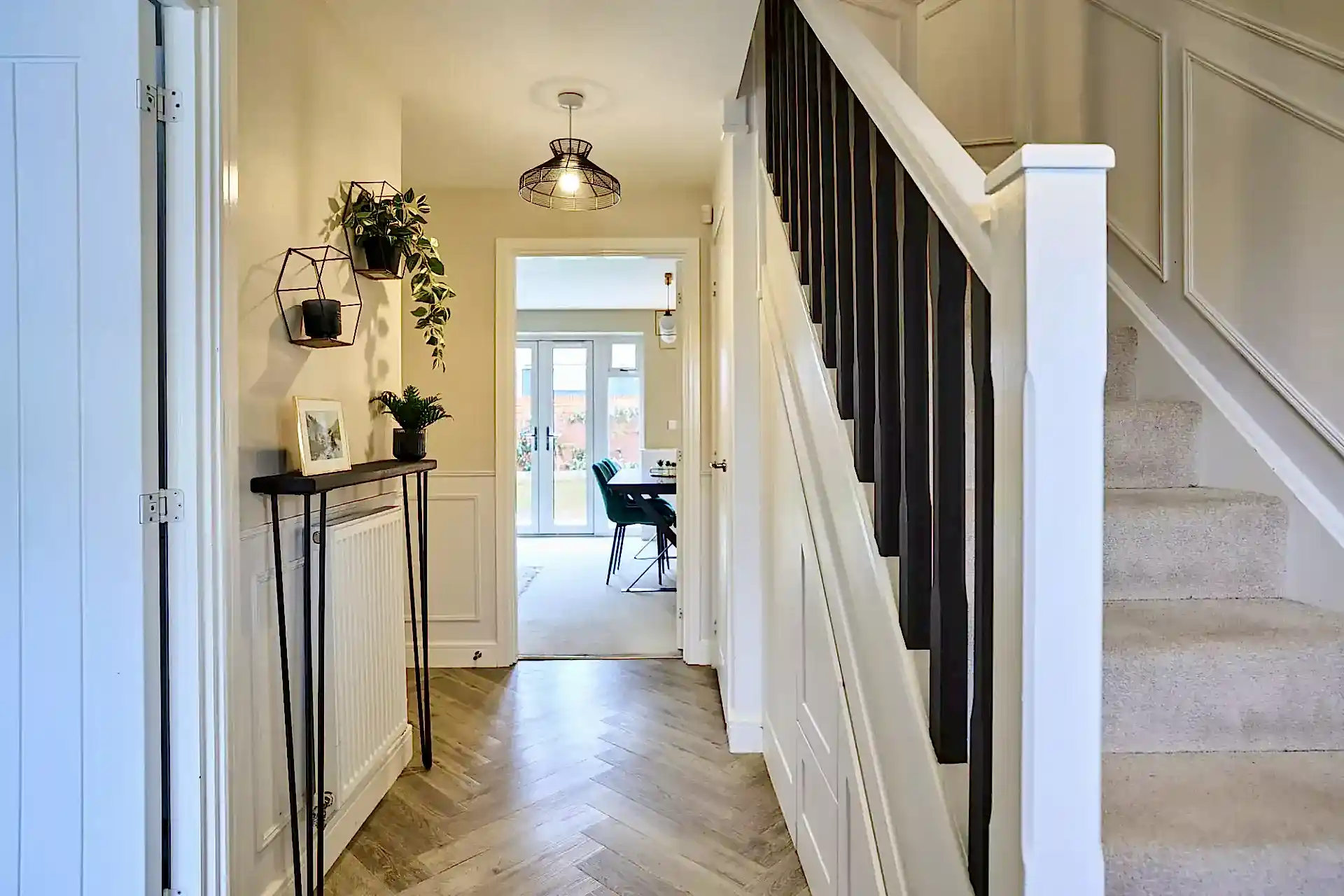 Monochromatic hallway with herringbone flooring